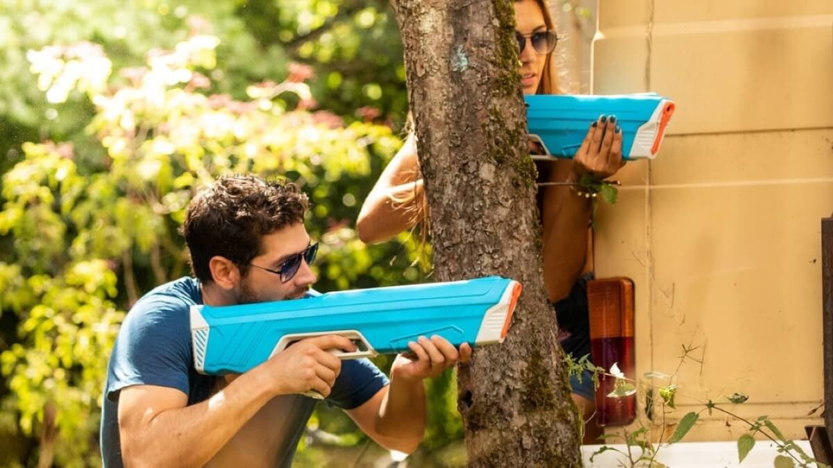 Group playing Water Wars with water blasters